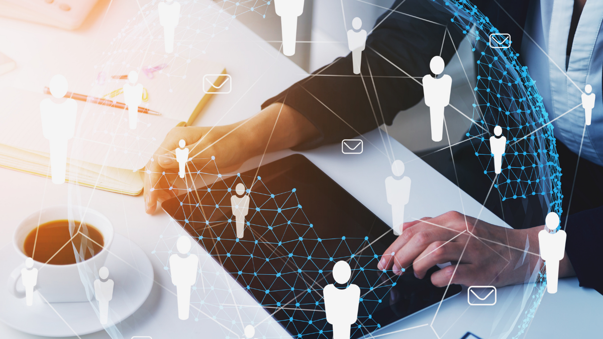 Close-up of a person's hands using a tablet displaying a connected global network